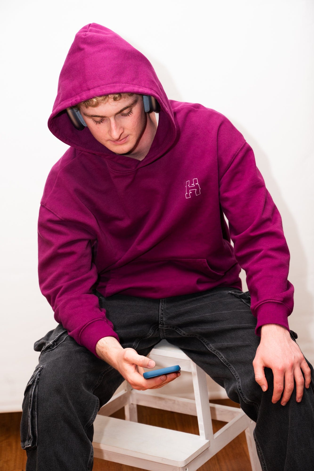 H3ners x SpaceHood hoodie in berry, worn with over-ear headphones under the hood